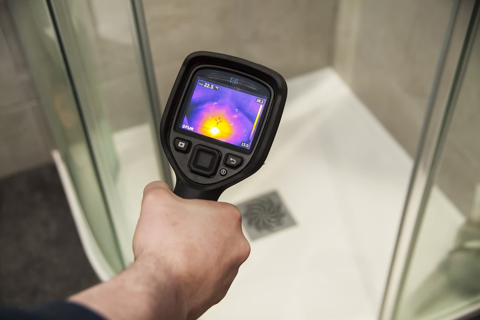 Thermal imaging camera detecting a hidden water leak beneath a shower tray